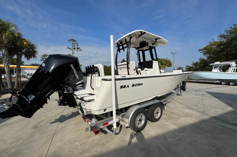 Slide: The Image of 2026 Sea Born LX24 Center Console boat on trailer, parked outdoors. - 11