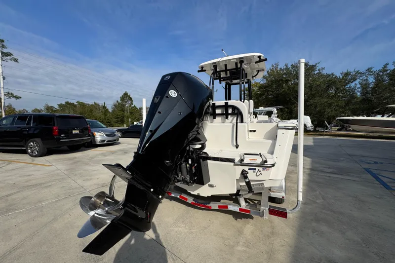 Slide: The Image of 2026 Sea Born LX24 Center Console boat with powerful outboard motor in parking lot. - 13