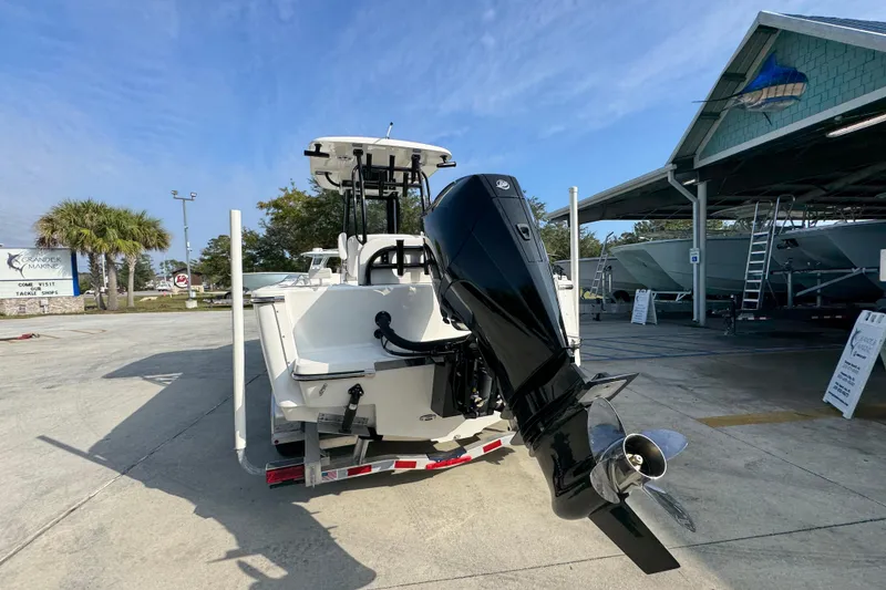 Slide: The Image of 2026 Sea Born LX24 Center Console boat with outboard motor at marina. - 15