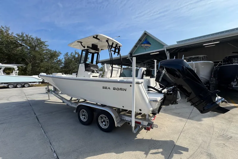Slide: The Image of 2026 Sea Born LX24 Center Console boat on trailer, parked outdoors. - 17