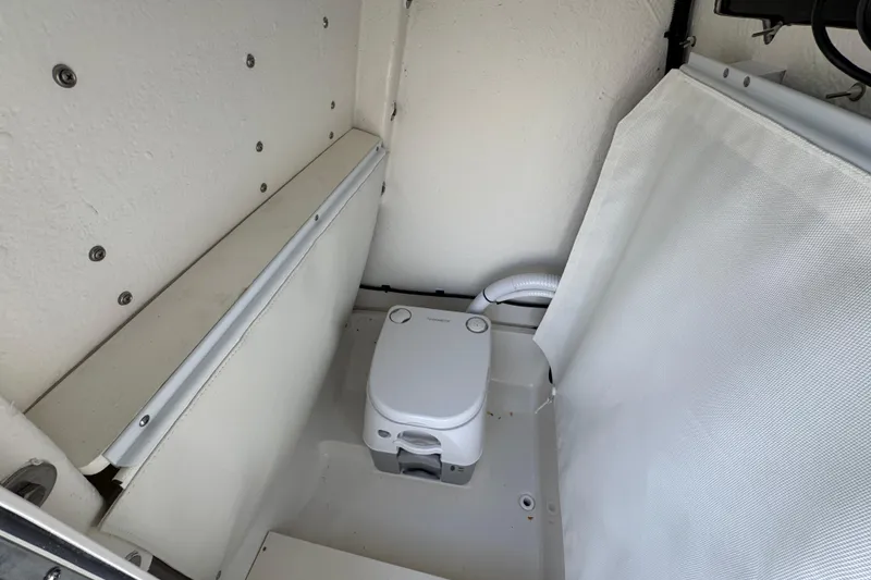 Slide: The Image of 2026 Sea Born LX24 Center Console boat interior with compact marine toilet. - 27