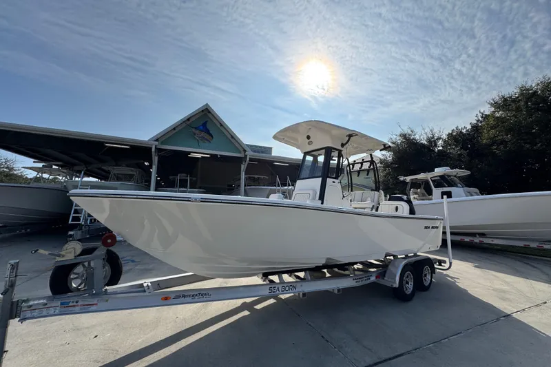 Slide: The Image of 2026 Sea Born LX24 Center Console boat on trailer under sunny sky. - 3