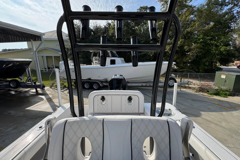 Slide: The Image of 2026 Sea Born LX24 Center Console boat with sleek design, parked outdoors. - 32