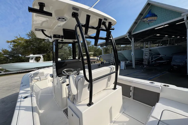 Slide: The Image of 2026 Sea Born LX24 Center Console boat at a marina, showcasing sleek design and spacious deck. - 39