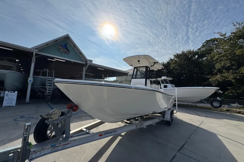 Slide: The Image of 2026 Sea Born LX24 Center Console boat on trailer under sunny sky. - 4