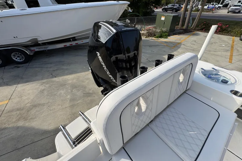 Slide: The Image of 2026 Sea Born LX24 Center Console boat with Mercury engine, parked on concrete. - 46