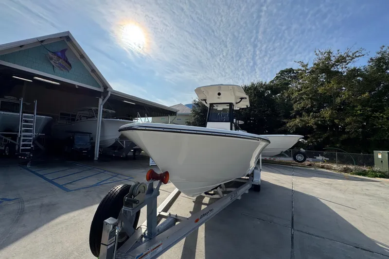 Slide: The Image of 2026 Sea Born LX24 Center Console boat on trailer under sunny sky. - 5