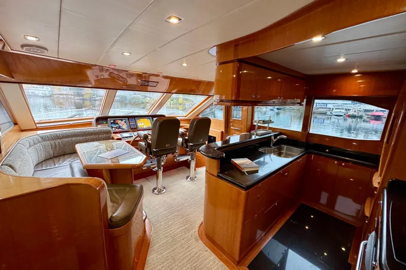 Slide: The Image of Luxurious interior of 2013 Hampton 620 Pilothouse yacht with modern helm and kitchen. - 13