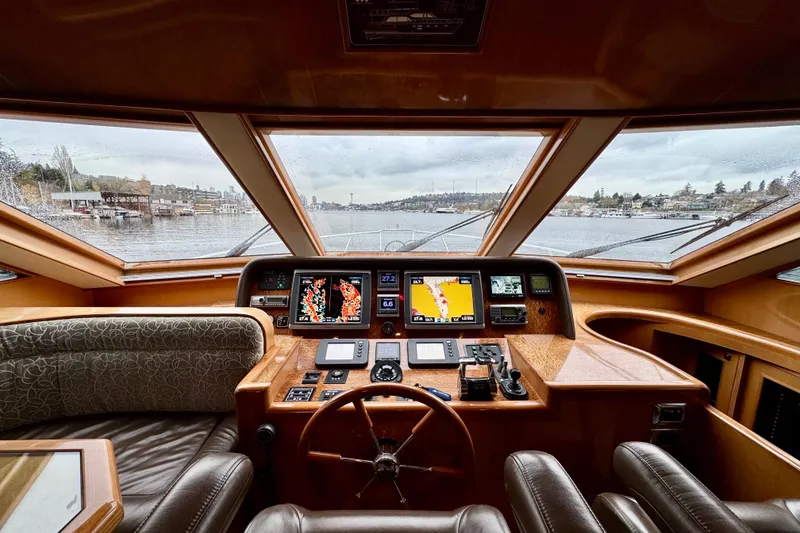 Slide: The Image of Pilothouse interior of 2013 Hampton 620, featuring navigation controls and panoramic windows. - 18