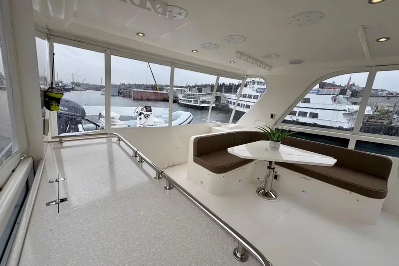 Slide: The Image of Luxurious interior of 2013 Hampton 620 Pilothouse yacht with seating and table. - 2