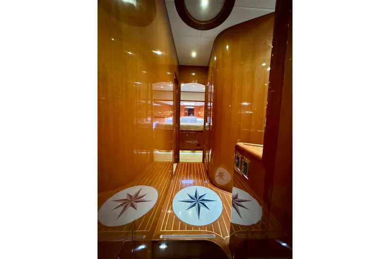 Slide: The Image of Luxurious interior of 2013 Hampton 620 Pilothouse yacht with polished wood and star motifs. - 20