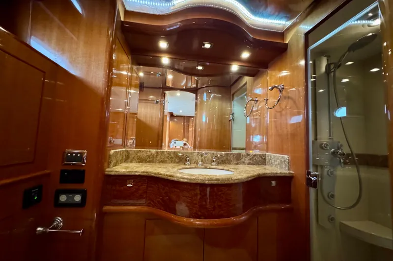 Slide: The Image of Luxurious bathroom in 2013 Hampton 620 Pilothouse yacht with elegant wood and marble finishes. - 22