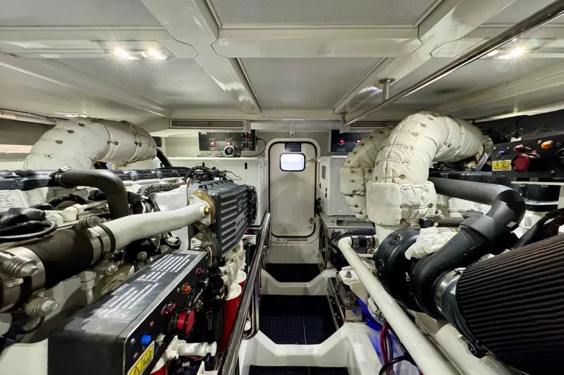 Slide: The Image of Engine room of 2013 Hampton 620 Pilothouse yacht, showcasing machinery and components. - 27