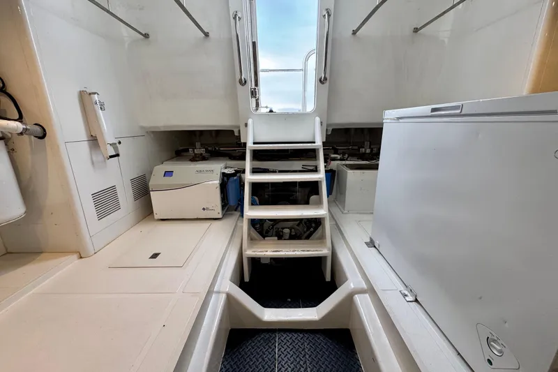 Slide: The Image of Engine room of 2013 Hampton 620 Pilothouse yacht with equipment and stairs. - 29