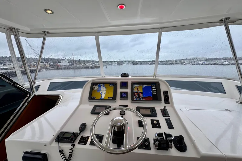 Slide: The Image of Pilothouse of 2013 Hampton 620 yacht with navigation screens and steering wheel. - 3