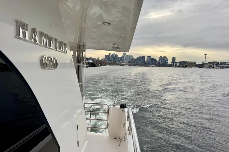 Slide: The Image of Hampton 620 Pilothouse yacht cruising with city skyline in the background, 2013 model. - 6