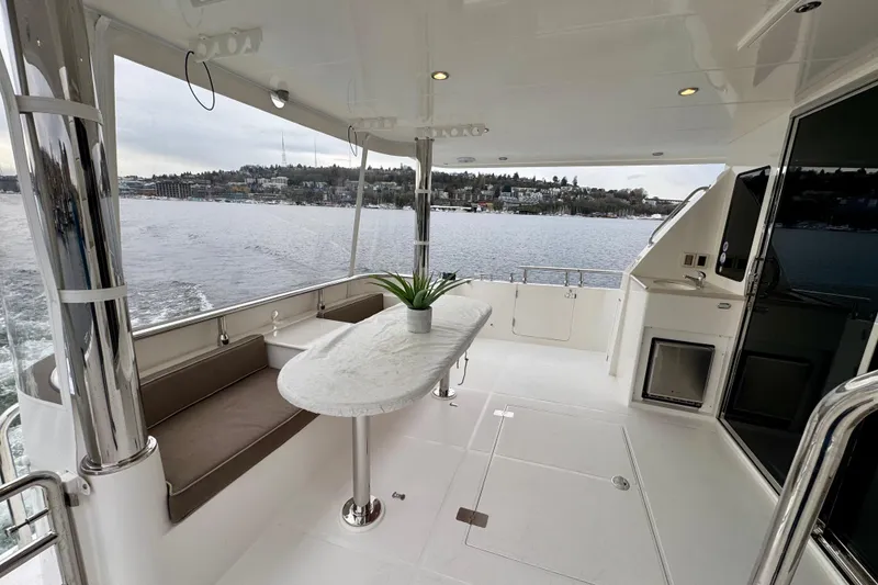 Slide: The Image of Luxurious 2013 Hampton 620 Pilothouse yacht deck with seating and scenic water view. - 9