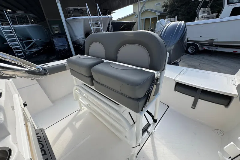 Slide: The Image of 2026 Sea Born LX21 Center Console boat interior with dual seats and steering wheel. - 27