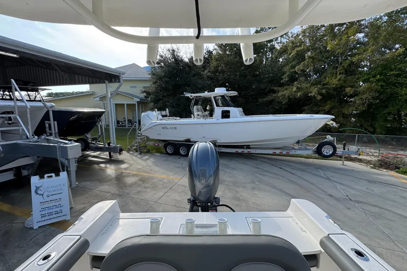 Slide: The Image of 2026 Sea Born LX21 Center Console boat in a marina, surrounded by trees and other boats. - 29