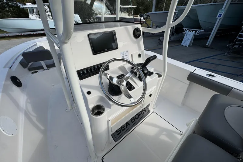 Slide: The Image of 2026 Sea Born LX21 Center Console boat interior with steering wheel and control panel. - 30
