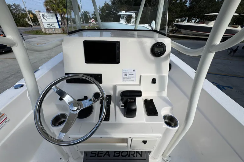 Slide: The Image of 2026 Sea Born LX21 Center Console boat dashboard with steering wheel and controls. - 31