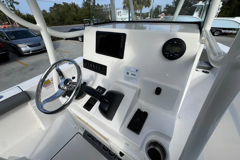 Slide: The Image of 2026 Sea Born LX21 Center Console boat dashboard with steering wheel and controls. - 33