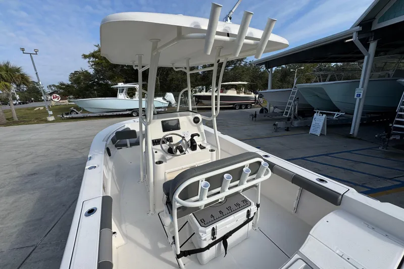 Slide: The Image of 2026 Sea Born LX21 Center Console boat with T-top and fishing rod holders. - 35