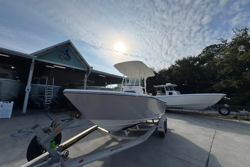 Slide: The Image of 2026 Sea Born LX21 Center Console boat on trailer under a cloudy sky. - 4