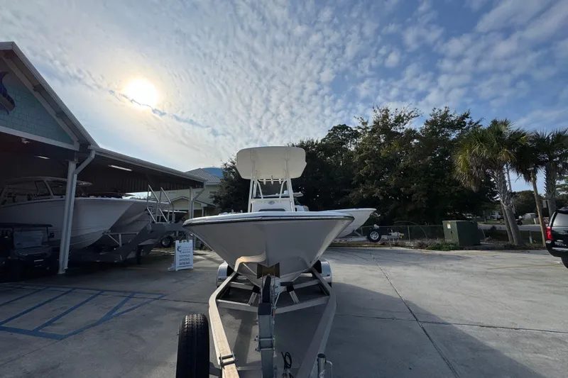 Slide: The Image of 2026 Sea Born LX21 Center Console boat on trailer under a cloudy sky. - 5