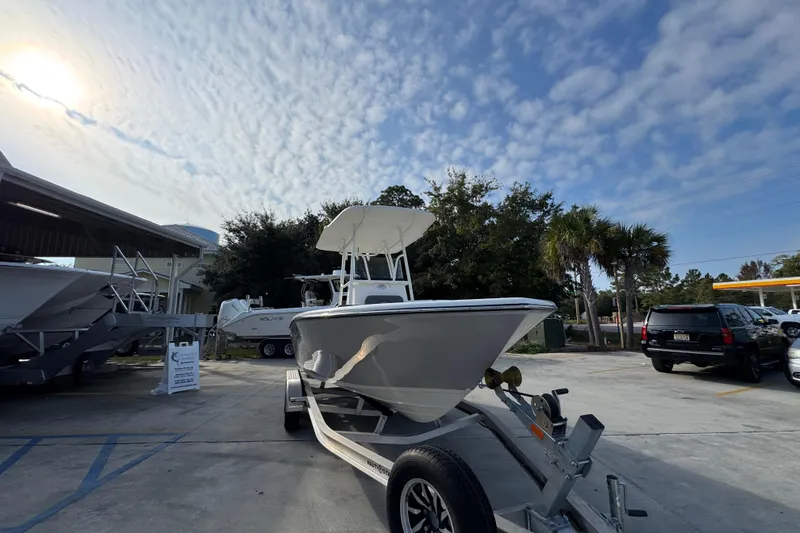 Slide: The Image of 2026 Sea Born LX21 Center Console boat on trailer under a partly cloudy sky. - 6