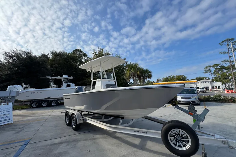 Slide: The Image of 2026 Sea Born LX21 Center Console boat on trailer under a partly cloudy sky. - 7