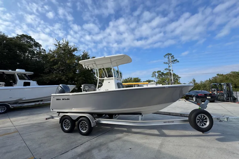 Slide: The Image of 2026 Sea Born LX21 Center Console boat on trailer, parked outdoors. - 8