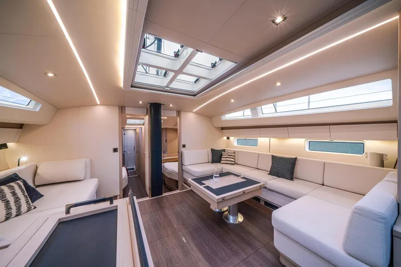 Slide: The Image of Luxurious interior of 2024 Jeanneau 65 yacht with modern seating and skylights. - 19