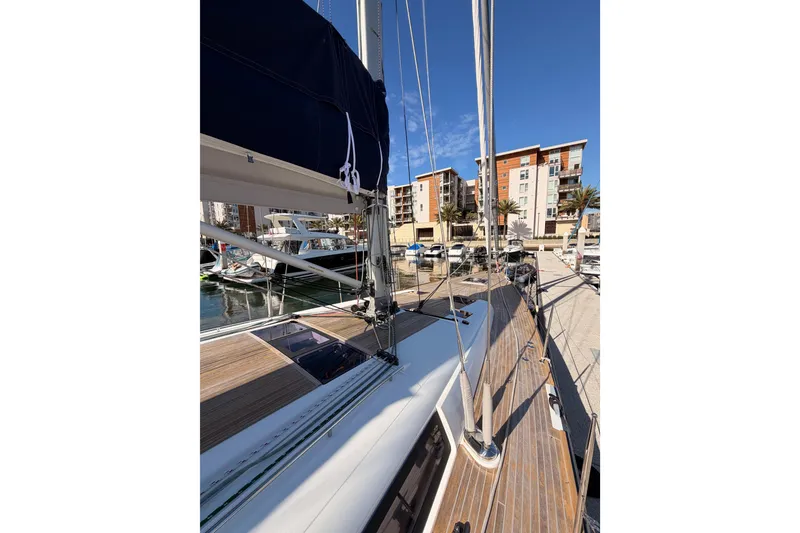 Slide: The Image of Beneteau Oceanis Yacht 60, 2015 model, docked at marina with clear blue sky. - 10