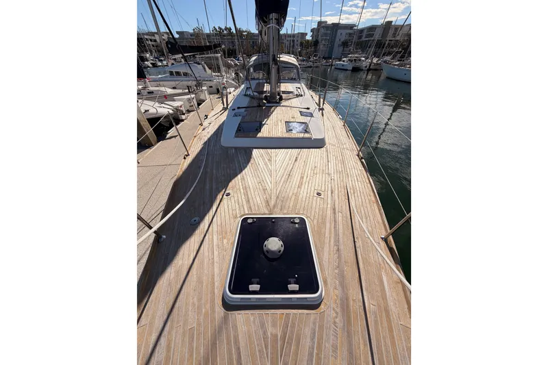 Slide: The Image of 2015 Beneteau Oceanis Yacht 60 with teak deck, docked in marina. - 14