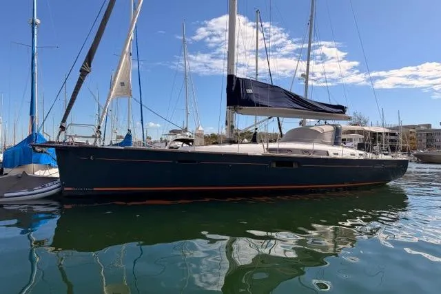 Slide: The Image of Beneteau Oceanis Yacht 60, 2015 model, docked in a sunny marina. - 2