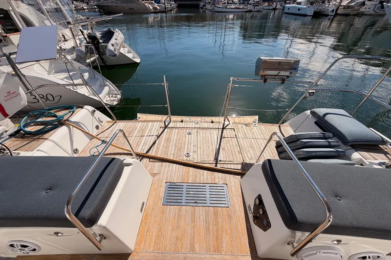 Slide: The Image of Beneteau Oceanis Yacht 60, 2015 model, docked with spacious deck and seating area. - 21