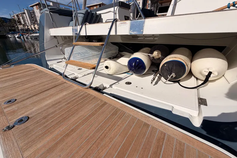 Slide: The Image of Beneteau Oceanis Yacht 60, 2015 model, with fenders and wooden deck at marina. - 23
