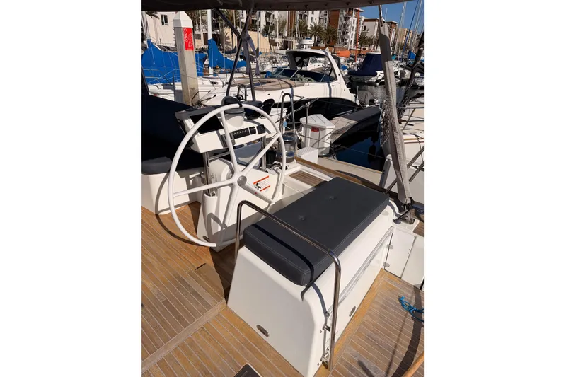 Slide: The Image of Steering area of 2015 Beneteau Oceanis Yacht 60 in marina setting. - 28