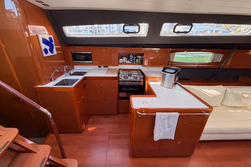 Slide: The Image of Luxurious interior of 2015 Beneteau Oceanis Yacht 60 with modern kitchen and seating area. - 40