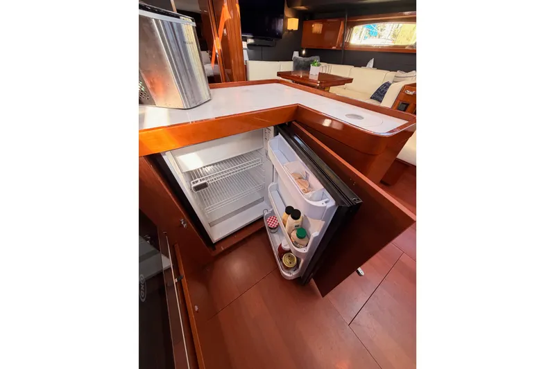Slide: The Image of Interior of 2015 Beneteau Oceanis Yacht 60 with open fridge in modern kitchen. - 43