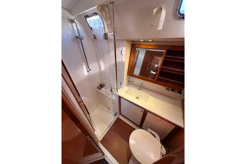 Slide: The Image of Luxurious bathroom in 2015 Beneteau Oceanis Yacht 60 with shower, sink, and toilet. - 49