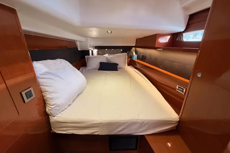 Slide: The Image of Luxurious cabin interior of 2015 Beneteau Oceanis Yacht 60 with cozy bed and wooden finish. - 51