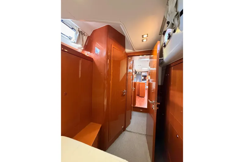 Slide: The Image of Interior of 2015 Beneteau Oceanis Yacht 60, featuring polished wood finishes and modern design. - 54