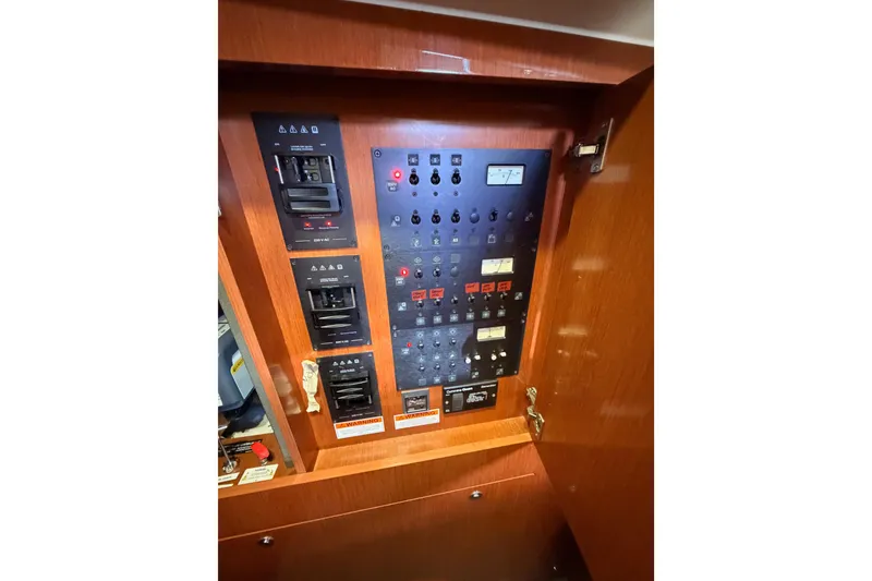 Slide: The Image of Electrical control panel inside 2015 Beneteau Oceanis Yacht 60, featuring switches and indicators. - 56