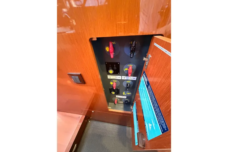 Slide: The Image of Electrical panel inside 2015 Beneteau Oceanis Yacht 60, featuring switches and controls. - 57