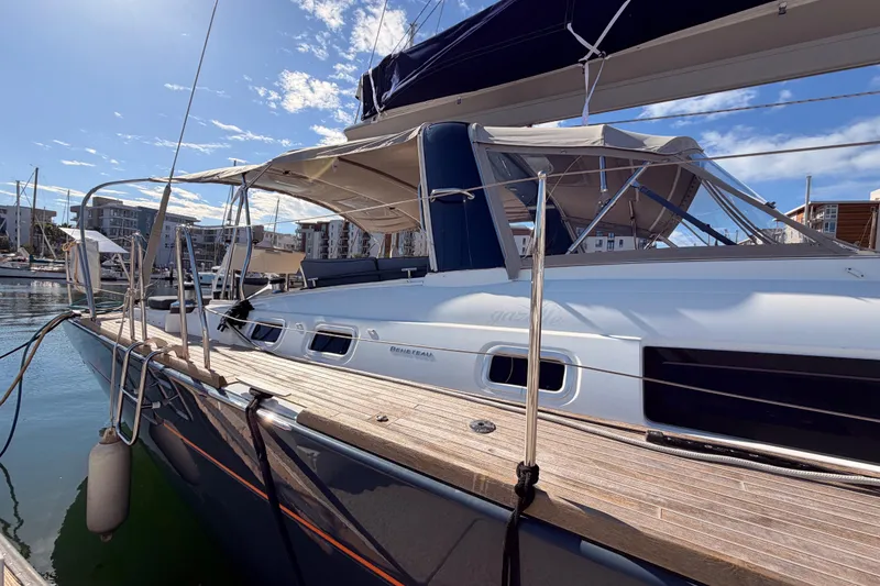 Slide: The Image of 2015 Beneteau Oceanis Yacht 60 docked in a sunny marina. - 7