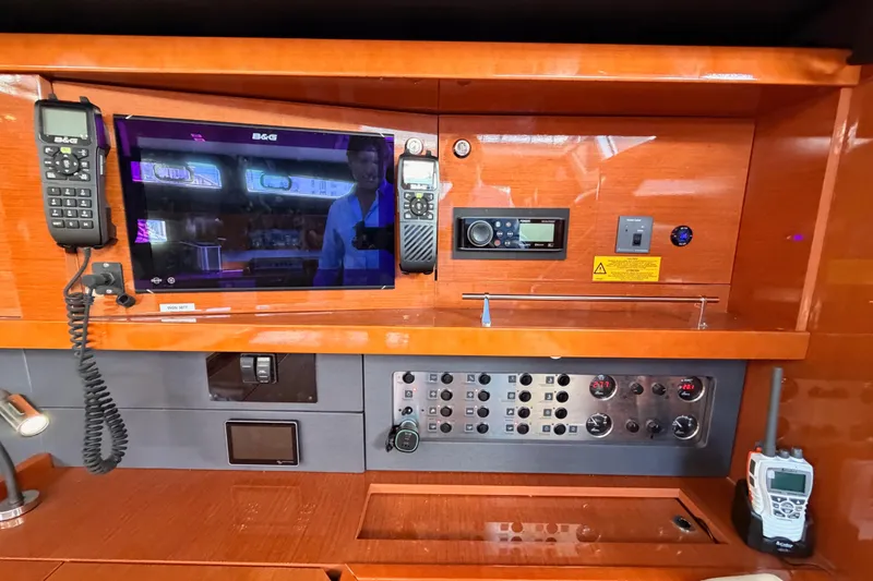 Slide: The Image of Control panel of a 2015 Beneteau Oceanis Yacht 60 with navigation and communication equipment. - 70