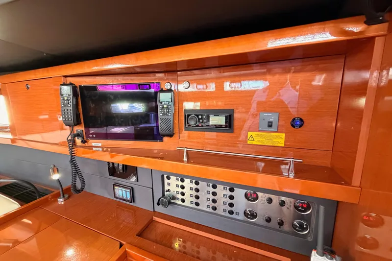 Slide: The Image of Control panel of 2015 Beneteau Oceanis Yacht 60 with navigation and communication equipment. - 72