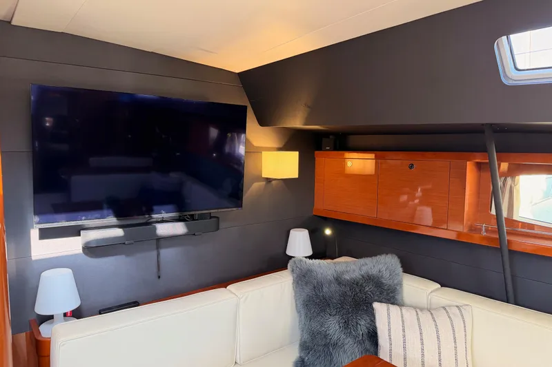Slide: The Image of Luxurious interior of 2015 Beneteau Oceanis Yacht 60 with TV and cozy seating area. - 76